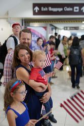 Family holding American flags at a patriotic event.