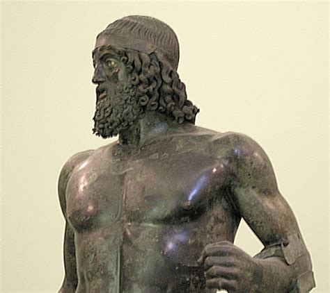 Ancient Greek bronze statue of a bearded man, showcasing detailed musculature and curly hair.