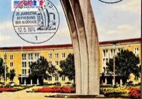 A monument with two large curved pillars in a landscaped area.