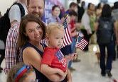 Family holding American flags at a patriotic event.