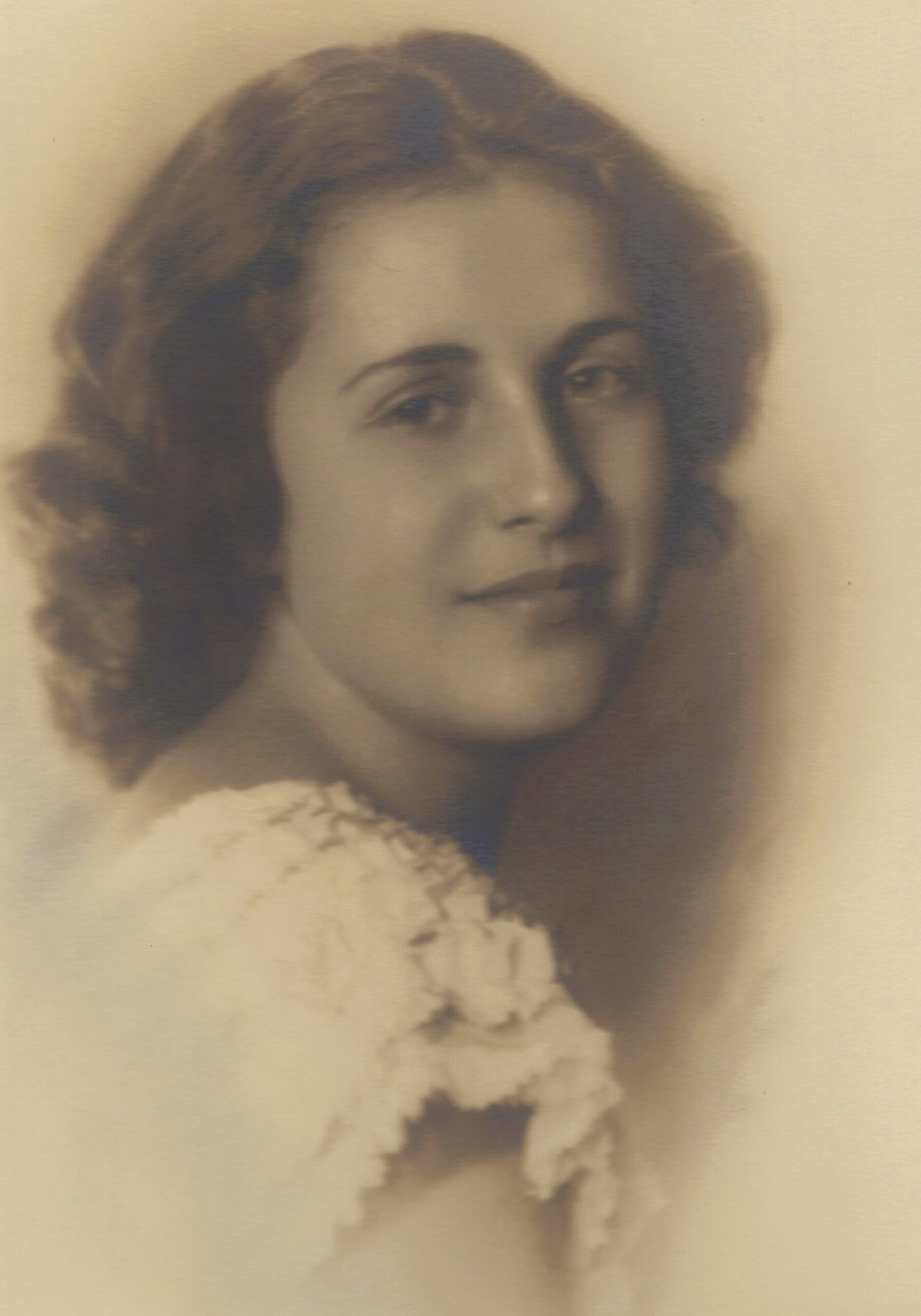 Vintage sepia portrait of a young woman in a lace dress.