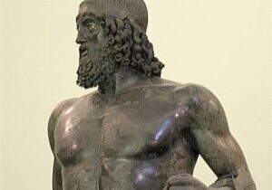 Ancient Greek bronze statue of a bearded man, showcasing detailed musculature and curly hair.