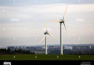 Two wind turbines on grassy hilltop